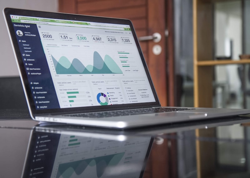 Laptop displaying financial analytics dashboard on office desk