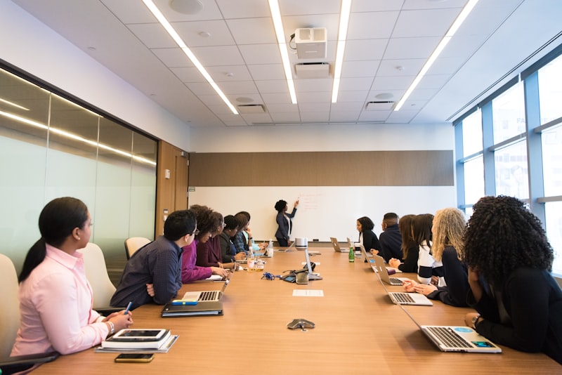Professionals in a formal boardroom meeting reviewing business strategy