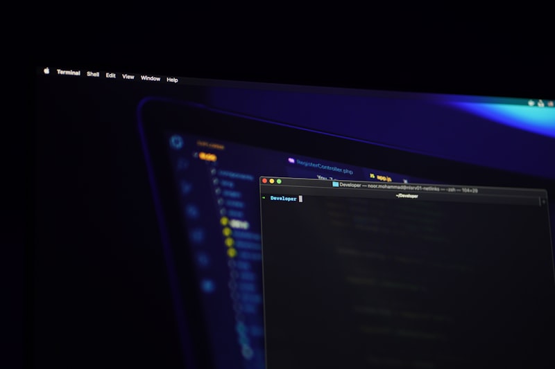 Terminal and code editor on screen with blue technology gradient
