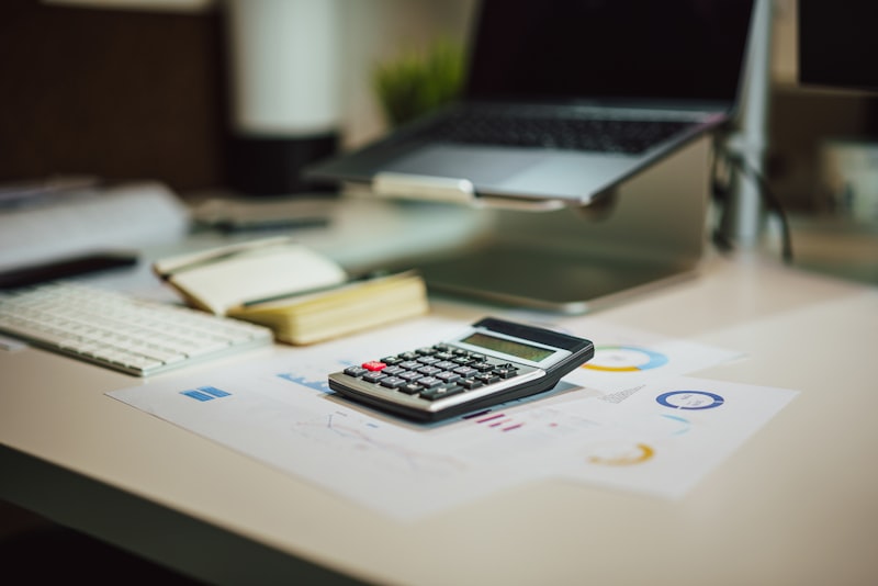 Calculator and pen resting on a notebook for tax preparation